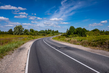 Fototapeta na wymiar Picturesque asphalt road, beautiful summer view, Pskov region, Russia