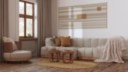 Fototapeta na wymiar Blurred background, farmhouse living room, rattan furniture, parquet floor and macrame wall art. Boho interior design