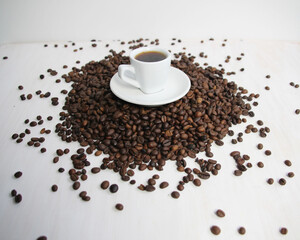cup of coffee with coffee beans on white background