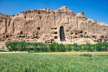 Afghanistan, Bamiyan (Bamian or Bamyan), cultural landscape and archeological remains, UNESCO World Heritage site, consolidation work, cliff and empty niche where Buddha statues were destroyed - obrazy, fototapety, plakaty