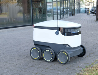 Autonomous delivery robot on Tallinn, Estonia. Estonian company developing autonomous delivery vehicles. Concept of future, technology, unmanned courier robot.