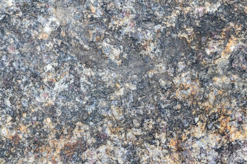 Texture of a stone wall with cracks and scratches which can be used as a backgr. The texture of the stone.