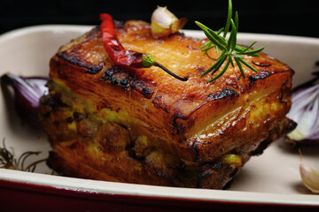 Roasted pork with garlic and turmeric. Beautiful background, homemade food, rustic.