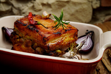 Roasted pork with garlic and turmeric. Beautiful background, homemade food, rustic.