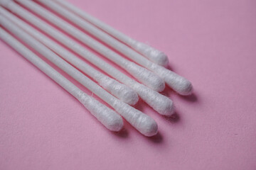 cotton swabs on the pink background, cosmetics and hygiene
