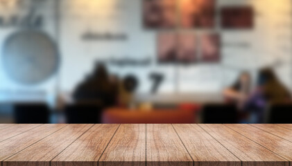Empty wooden table top with lights bokeh on blur restaurant background.
