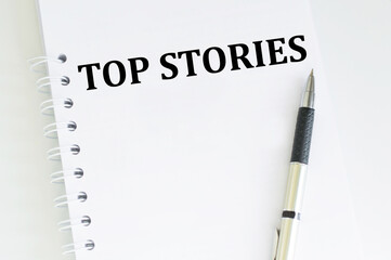 Top Story text on a notebook on a desk, a business concept