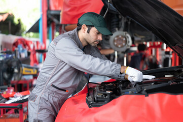 Fototapeta premium car service, repair, maintenance concept - Arab auto mechanic man or Smith Checking/repair machine at workshop warehouse, technician doing the checklist for repair machine a car in the garage