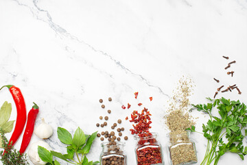 Culinary background with spices. Cooking. Fresh herbs and spices in jars on a gray stone background.