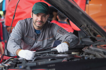 Fototapeta na wymiar car service, repair, maintenance concept - Arab auto mechanic man or Smith Checking/repair machine at workshop warehouse, technician doing the checklist for repair machine a car in the garage