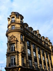 Fototapeta na wymiar Paris, September 2022 : Visit of the magnificent city of Paris, Capital of France - View on different facades of buildings built by Baron Haussmann