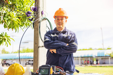 Outside, an ISP Internet Service Provider engineer stands near a fiber optic cross box.