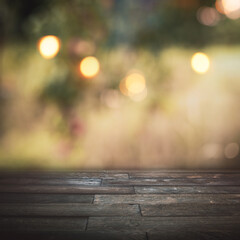 Blurred autumn background with golden bokeh and empty wooden table for a thanksgiving decoration...