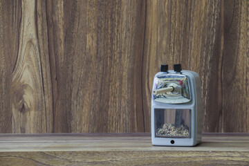 stapler placed on wooden table with copy space for vintage style wood grain background design