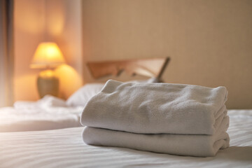 Fototapeta na wymiar White towel on the bed decoration in bedroom interior ,White towel on the bed in the hotel room 
