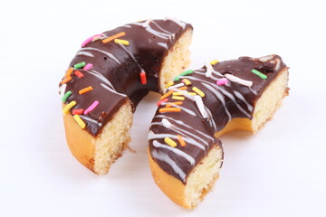 Chocolate sweet mini donuts on white background