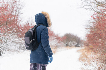 Fototapeta na wymiar Man with backpack walking in winter 