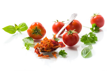 small pieces of dried tomatoes next to fresh tomatoes