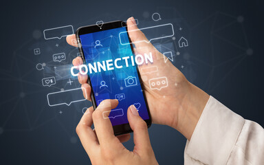 Hand using smartphone with social media concept