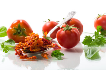 small pieces of dried tomatoes next to fresh tomatoes