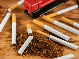 Cigarettes and tobacco on a wooden background. Smoking damages the lungs and kills.