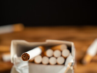 Cigarettes on a wooden background. Smoking damages the lungs and kills.
