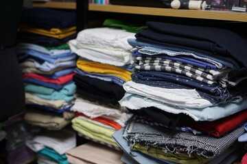 Shelves stacked with multiple fabrics