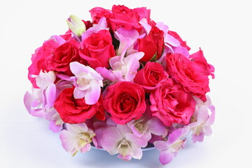 Bouquet of orchid and rose flowers in vase isolated on white background