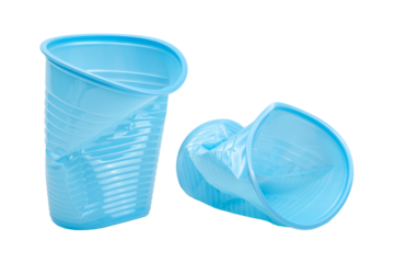 Crushed, damaged, discarded blue empty plastic cups, objects isolated on white background, cut out. Used plastic beverage cup trash, throwing away used plastic water cups, garbage, rubbish concept