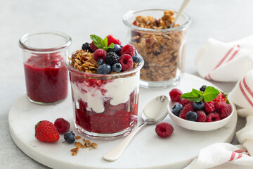 Healthy breakfast, fresh greek yogurt, granola and mixed berries in glass