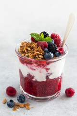 Healthy breakfast, fresh greek yogurt, granola and mixed berries in glass healthy food concept, white background