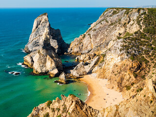 Amazing steep cliffs and stunning rocky formations dominating Ursa beach (praia da ursa), Cabo da Roca cape, Portugal 