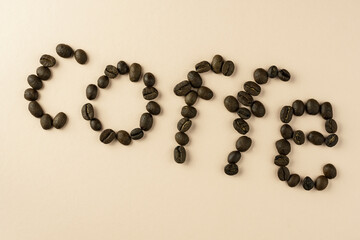 The word coffee is laid out from a grain of black coffee, with a place for the inscription.