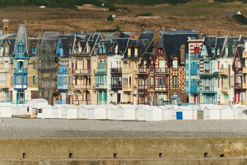 Traditional colorful facades along the dike at sunset in Mers-Les-Bains, Normandy, France