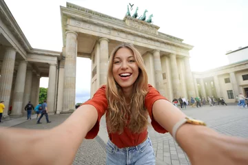 Fototapeten Self portrait of beautiful excited school exchange girl visiting Europe within the exchange program © zigres