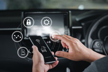Wireless connection technology in the smart car and virtual screens concept, Man use the smartphone  online to a car ,Connecting to the car system and safety technology,car inside background