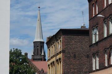 Fototapeta na wymiar Upper Silesia. Tower of Saint Apostles Peter and Paul Church (Kosciol Swietych Apostolow Piotra i Pawla) in background. Swietochlowice, Poland.