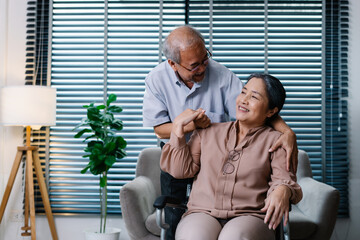Fototapeta na wymiar Elderly husband take care wife who sitting on wheelchair in living room, Senior couple take care of each other, Happy Life Retirement and Healthcare