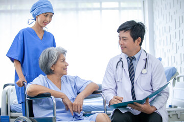 Obraz premium asian doctor with stethoscope and document folder, examine the symptom for senior patient in the recovery room. Healthcare and medicine concept.