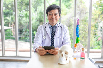 doctor with stethoscope using smartphone in office.