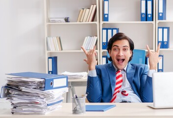 Young happy male employee in the office