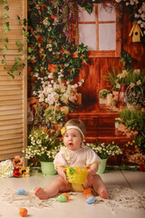 girl one year old shooting in the studio in the background flowers wooden background