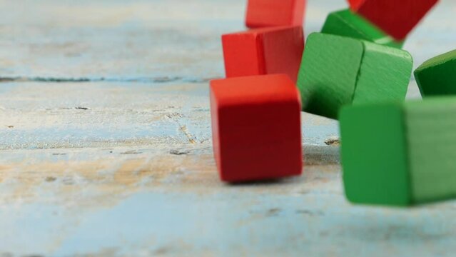Falling baby toy blocks on an old wooden vintage board. Slow motion.