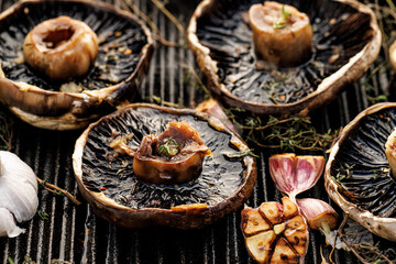 Grilled portobello mushrooms with herbs and garlic on a grill plate, close up view - 531466513