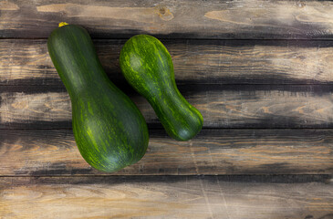 Raw zucchini on a wooden table. Top view, copy space