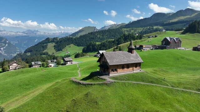 Fronalpstock Klingenstock wooden chapel in Stoos in central Switzerland a small wintersport ski resort village. Grassland alps alpine town on a clear sunny summer day. Clear mountain air and sky.