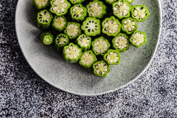 Overhead view of chopped okra on a plate
