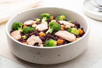 Healthy fried riceberry rice (brown jasmine rice) with chicken breast and broccoli carrot in white plate