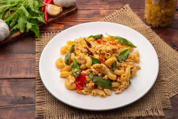 Stir-fried elbow macaroni with ground chicken in white plate,Pad Kra Pao,Thai fusion food