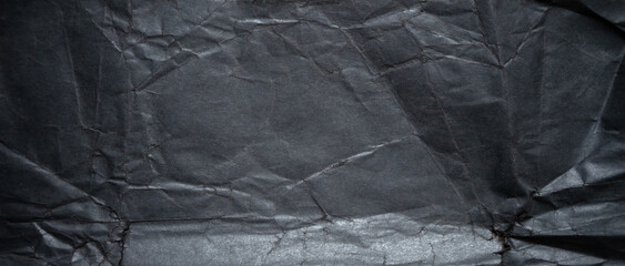 Rectangular texture of black paper. Photo of black photo paper. Black background for banner-shaped text.